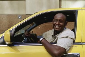 cab-driver-leaning-out-of-his-yellow-cab-1-1038x576-1.jpg